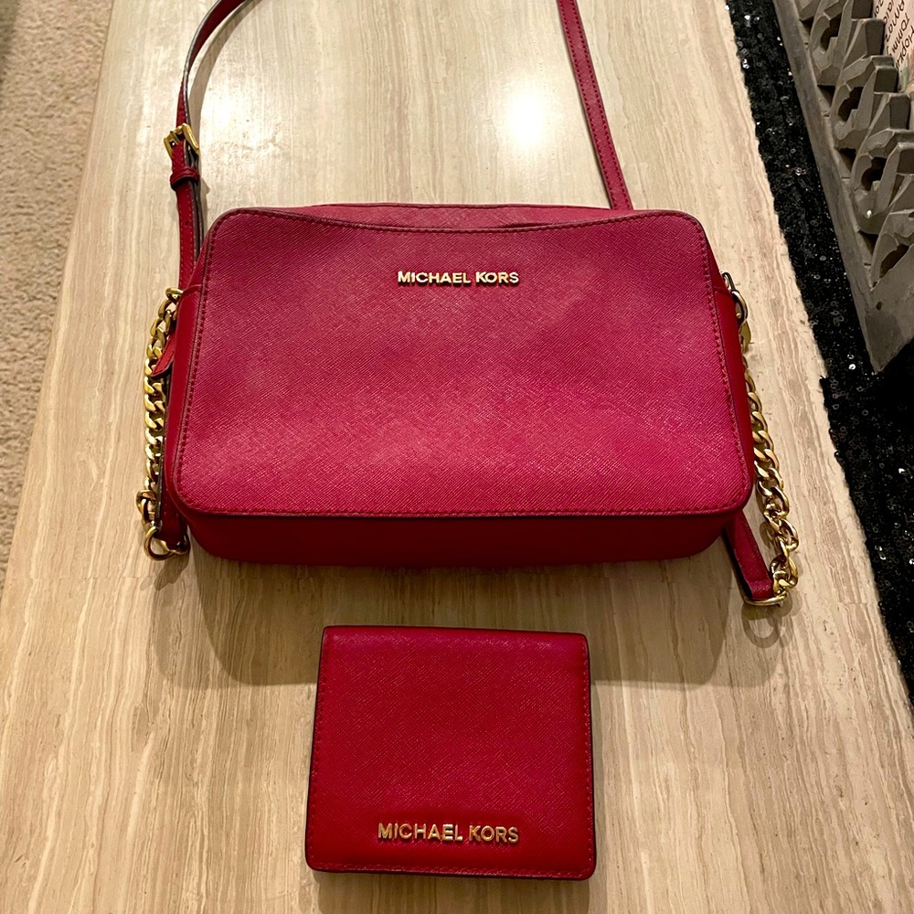 Michael Kors red purse and wallet sold as set. Slightly used.